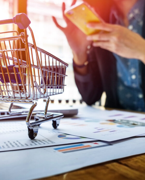 Cropped image of woman inputting card information and key on phone or laptop while shopping online.